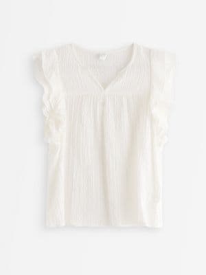 Sleeveless blouse with flounce